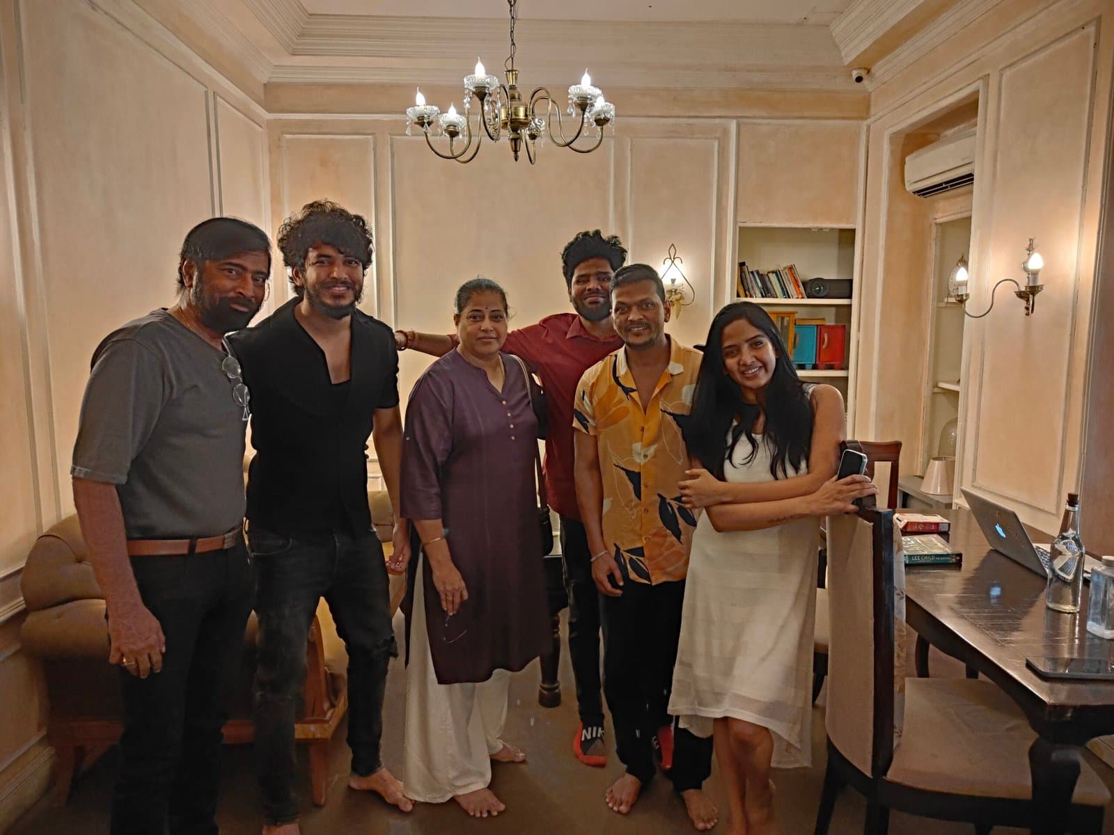 A cast and crew group photo in the lounge